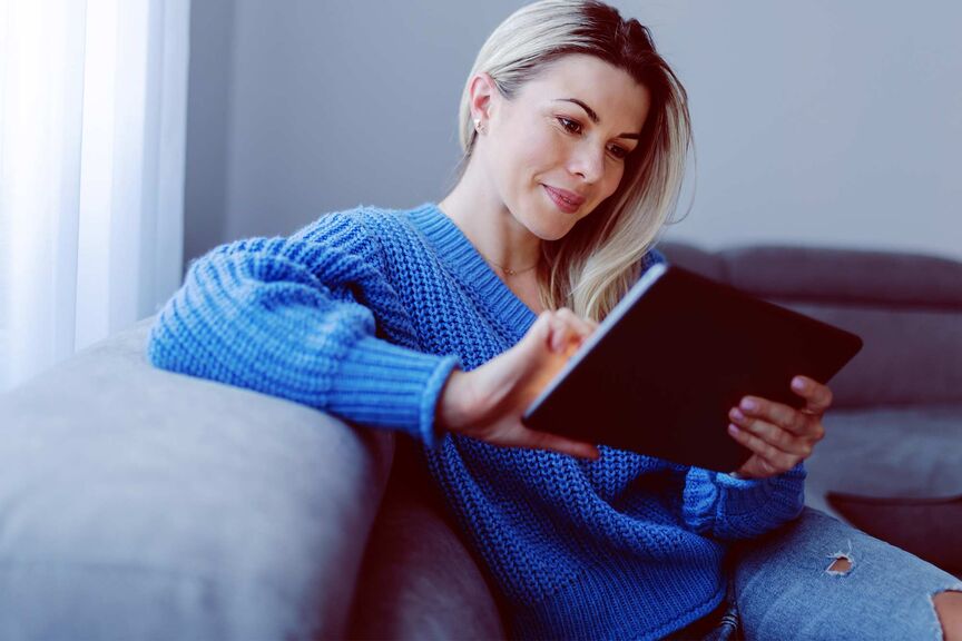 Young woman using a tablet on the couch