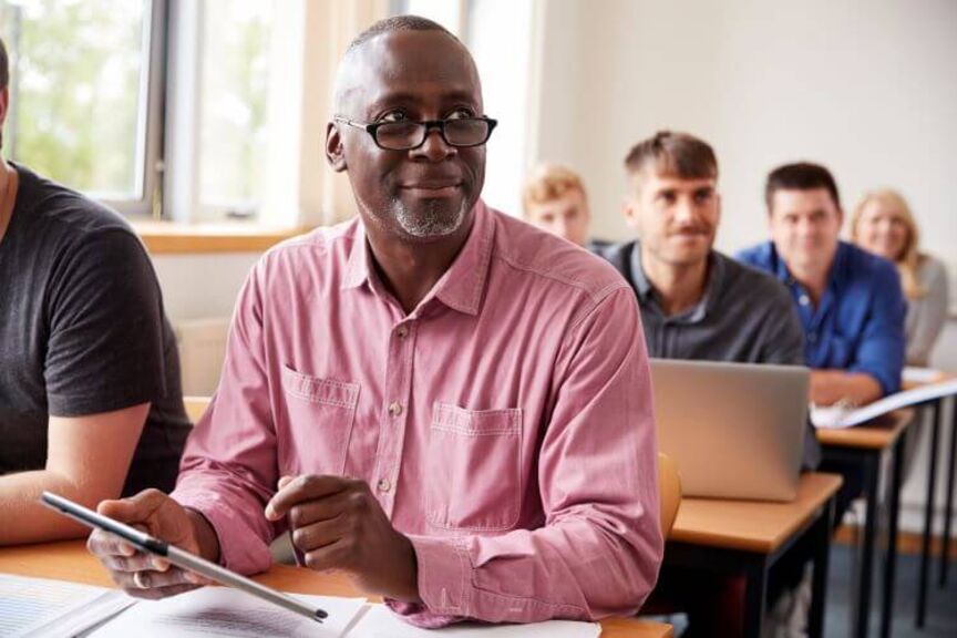 Older Black man in classroom
