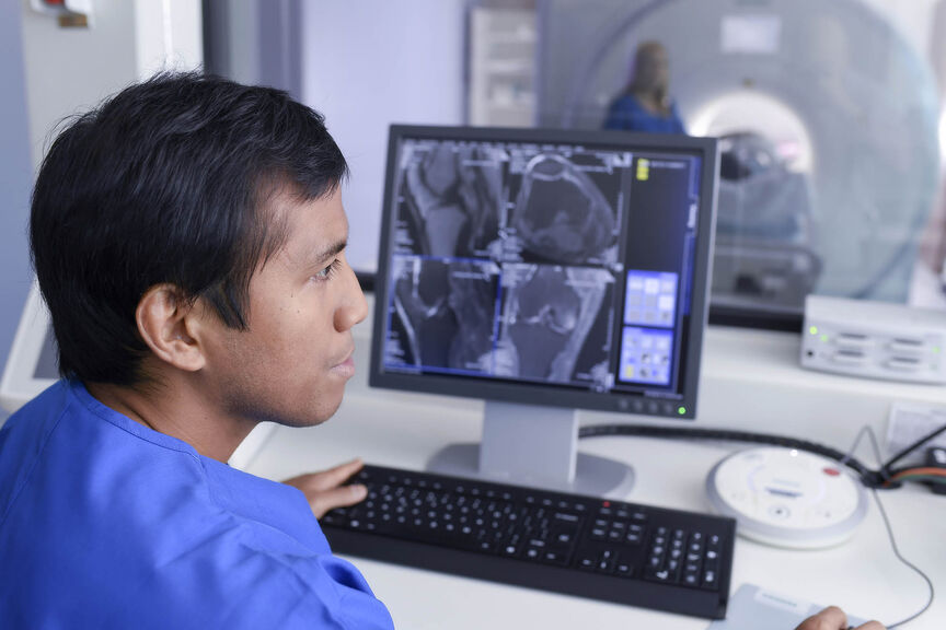 MRI Technician using a computer