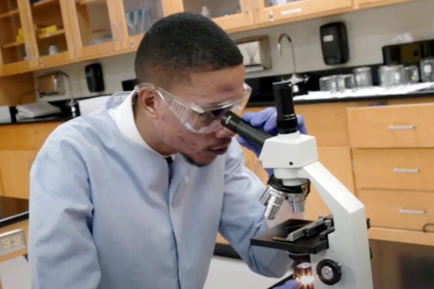 Sean Chin Chan using a microscope