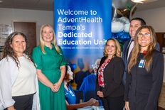 AHU and AdventHealth Tampa leaders in front of the DEU sign