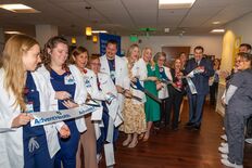 Nurses, students and AHU leaders cut the ribbon at the new dedicated education unit.