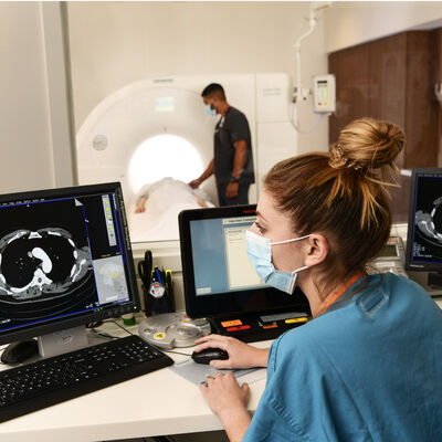 Technicians preform CT scan