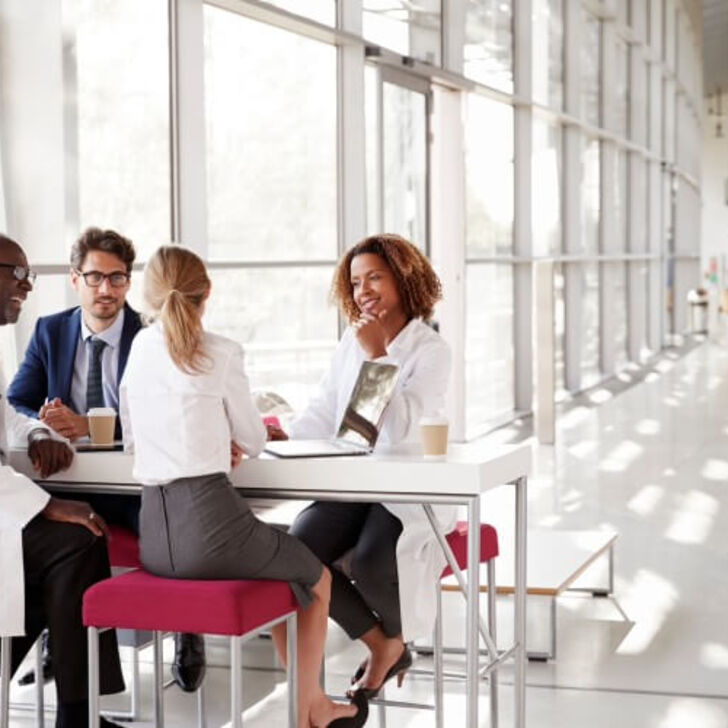 healthcare-administrators-sit-around-a-table