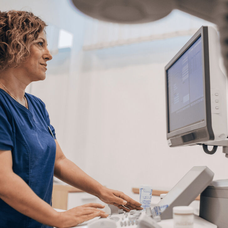 A healthcare worker looking at a computer display